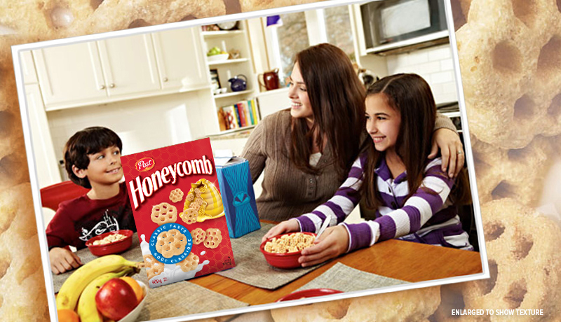 family at a kitchen table enjoying Honeycomb cereal