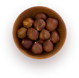 a wooden bowl of roasted hazelnuts.